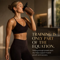 Woman drinking a protein shake after training